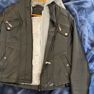 Fake leather jacket with fuzzy inside. Very comfortable. Has usable pockets.